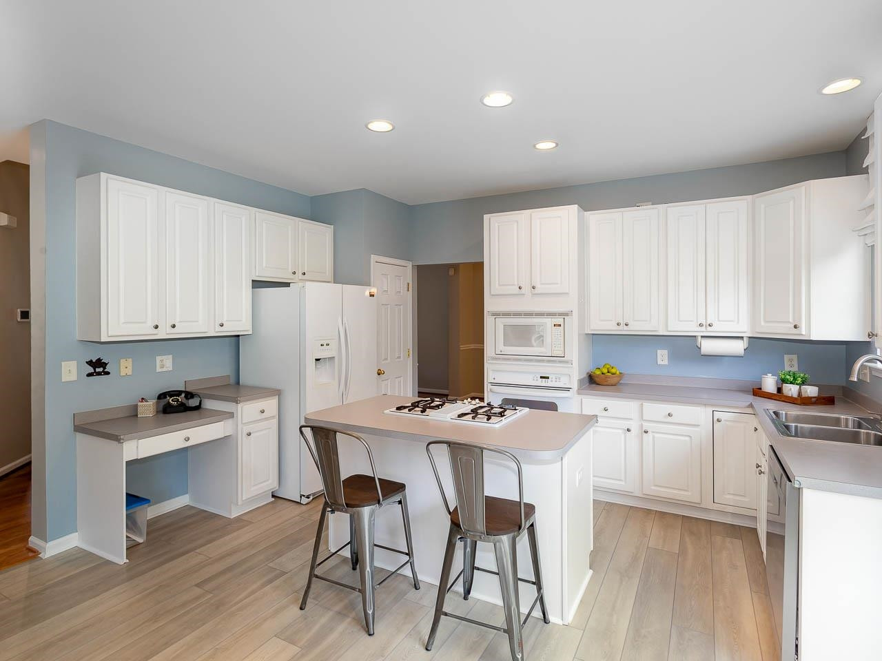 3702 Appling Way Durham, NC 27703 - Photo 5 of 34 a kitchen with white cabinets and white appliances