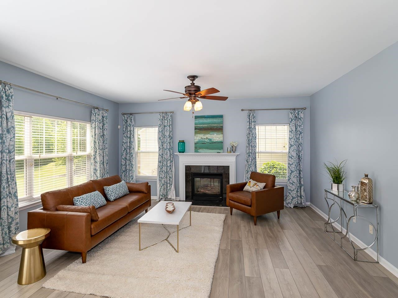 3702 Appling Way Durham, NC 27703 - Photo 8 of 34 a living room with furniture a fireplace and a floor to ceiling window