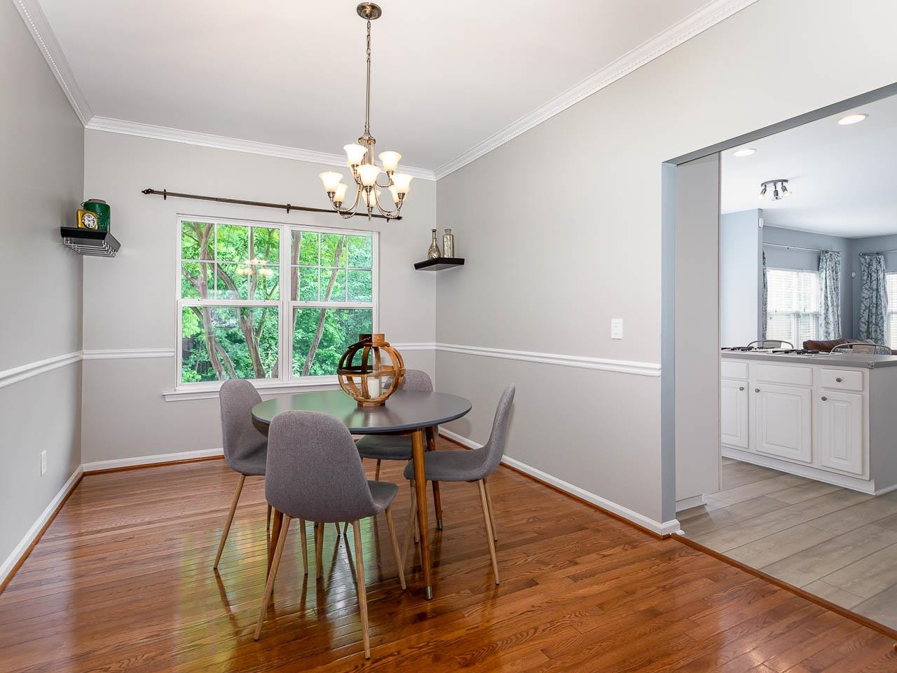 3702 Appling Way Durham, NC 27703 - Photo 9 of 34 a view of a dining room with furniture a chandelier and wooden floor