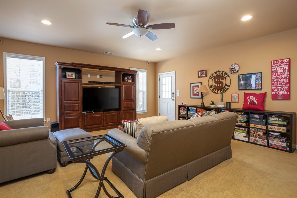 8206 Marvino Lane Raleigh, NC 27613 - Photo 19 of 30 Cuddle up for movie night or watch the big game in the den area of the finished basement! Additional space can be used as a game/rec room! Finished Basement