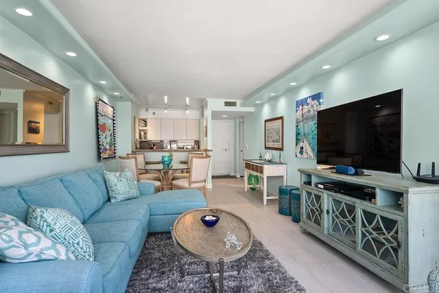 a dining room with furniture and painting on the wall