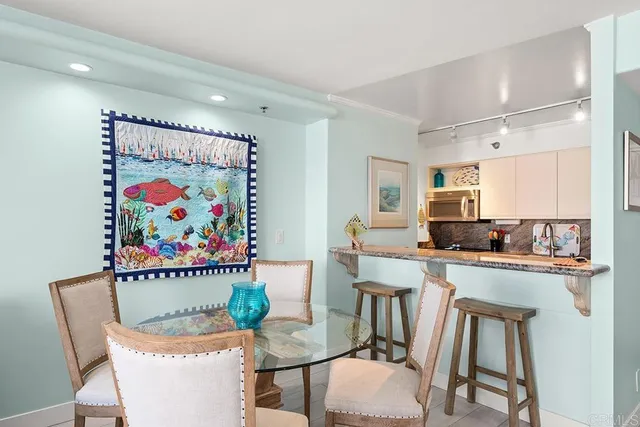 a kitchen with granite countertop a sink a stove and a wooden floor