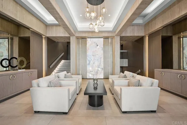 a living room with furniture and a chandelier