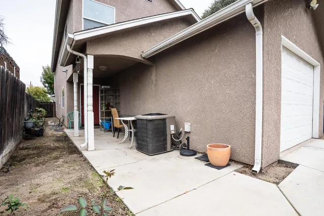 a view of a patio with a table and chairs