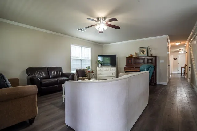 a living room with furniture and a flat screen tv