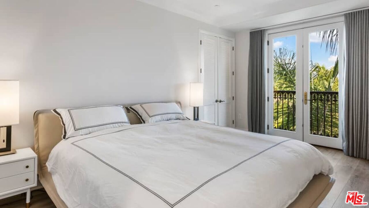 261 South Reeves Drive Beverly Hills, CA 90212 - Photo 18 of 43 a bedroom with a bed and a large window