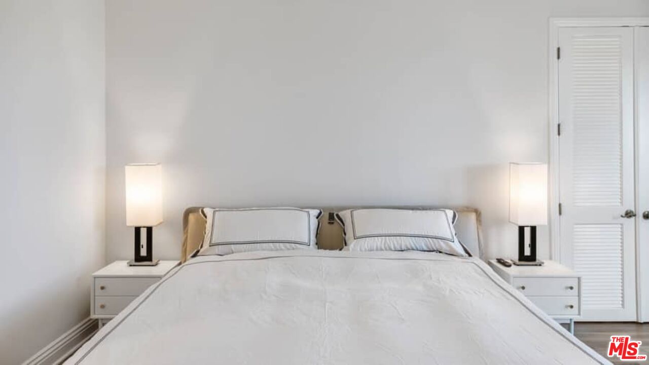 261 South Reeves Drive Beverly Hills, CA 90212 - Photo 19 of 43 a bedroom with a bed and a night lamp