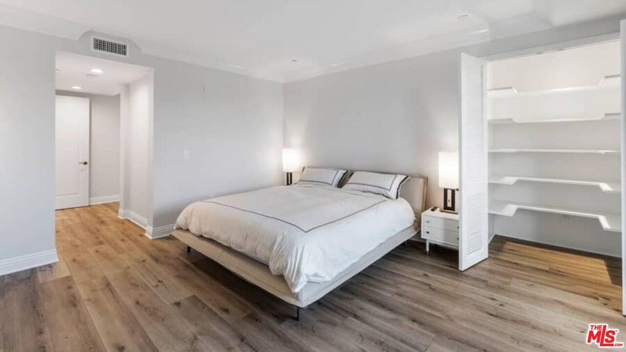261 South Reeves Drive Beverly Hills, CA 90212 - Photo 20 of 43 a bedroom with a bed and wooden floor