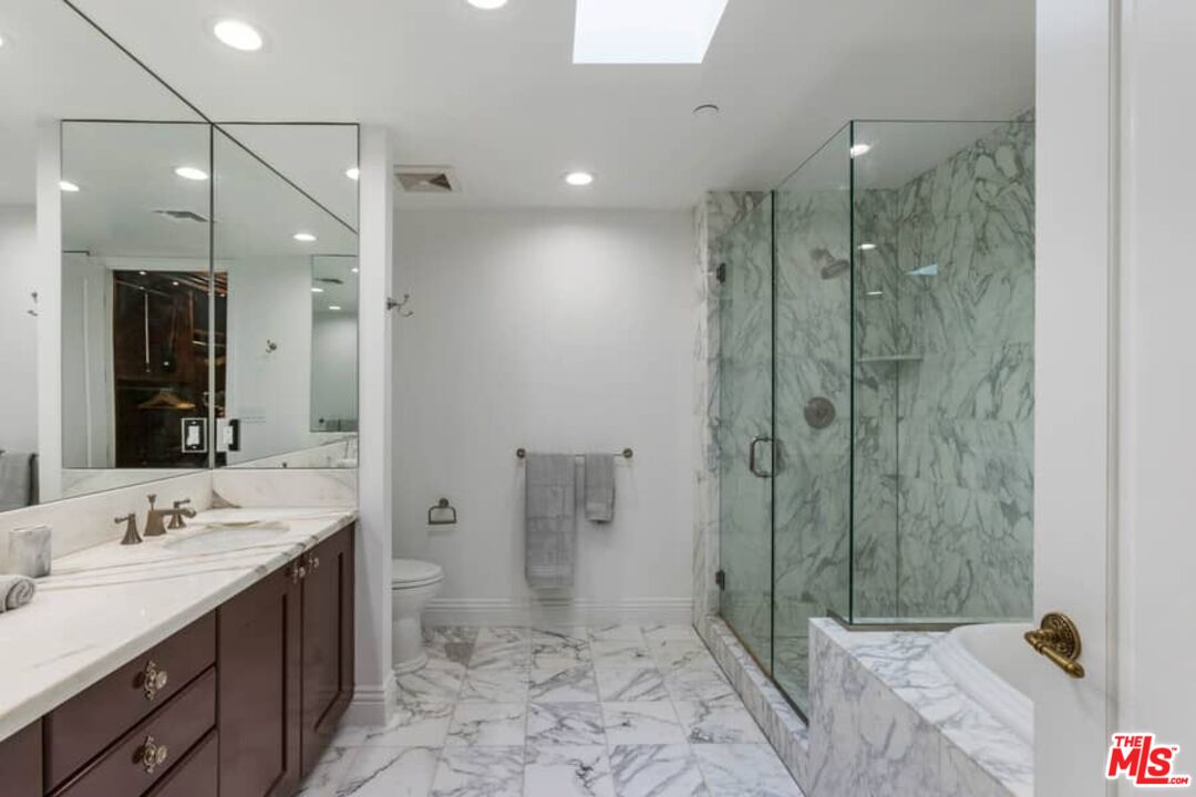 261 South Reeves Drive Beverly Hills, CA 90212 - Photo 22 of 43 a bathroom with a double vanity sink toilet and shower
