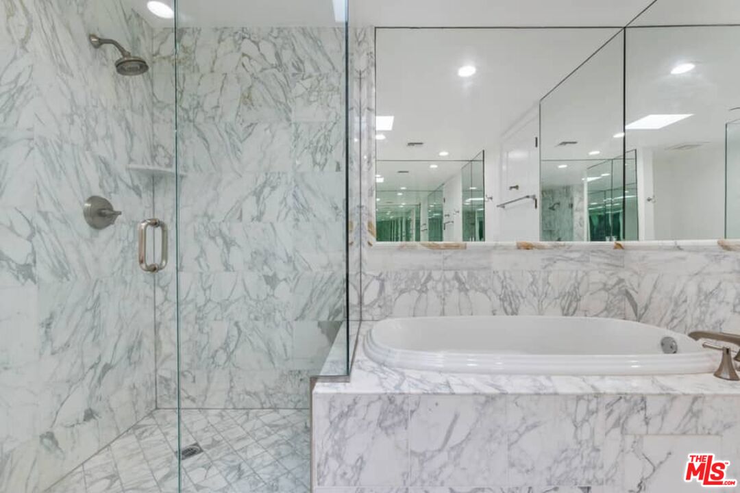 261 South Reeves Drive Beverly Hills, CA 90212 - Photo 23 of 43 a bathroom with a bathtub and a shower