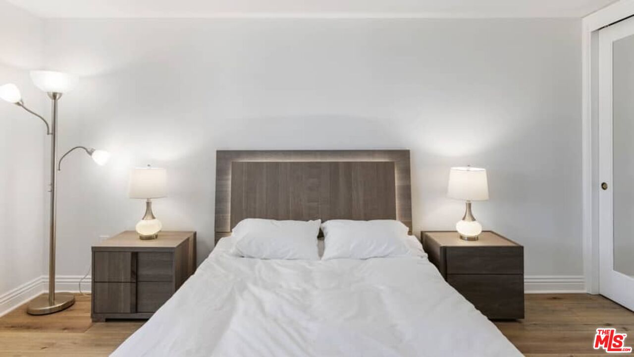 261 South Reeves Drive Beverly Hills, CA 90212 - Photo 26 of 43 a bedroom with a bed and a lamp