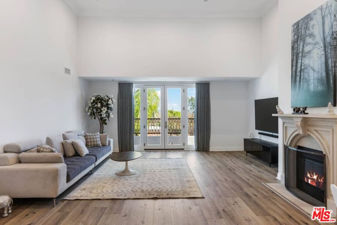 261 South Reeves Drive Beverly Hills, CA 90212 - Photo 3 of 43 a living room with furniture and a fireplace