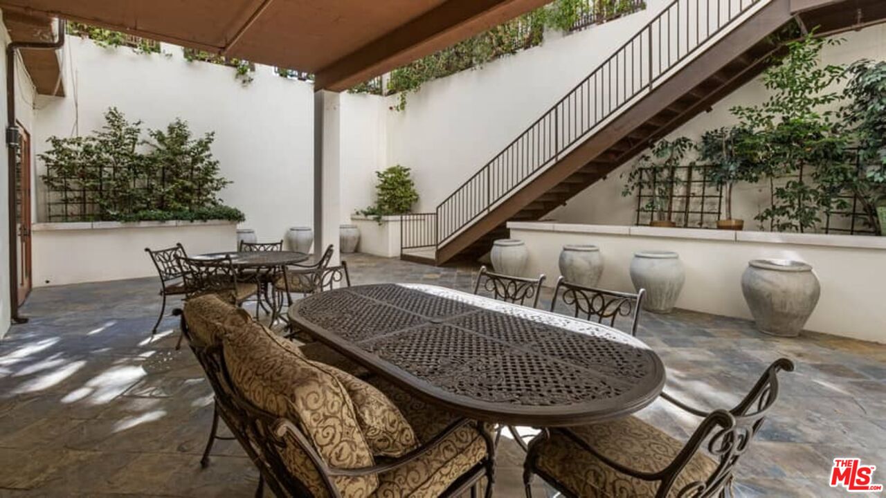 261 South Reeves Drive Beverly Hills, CA 90212 - Photo 36 of 43 a view of a chairs and table in the patio