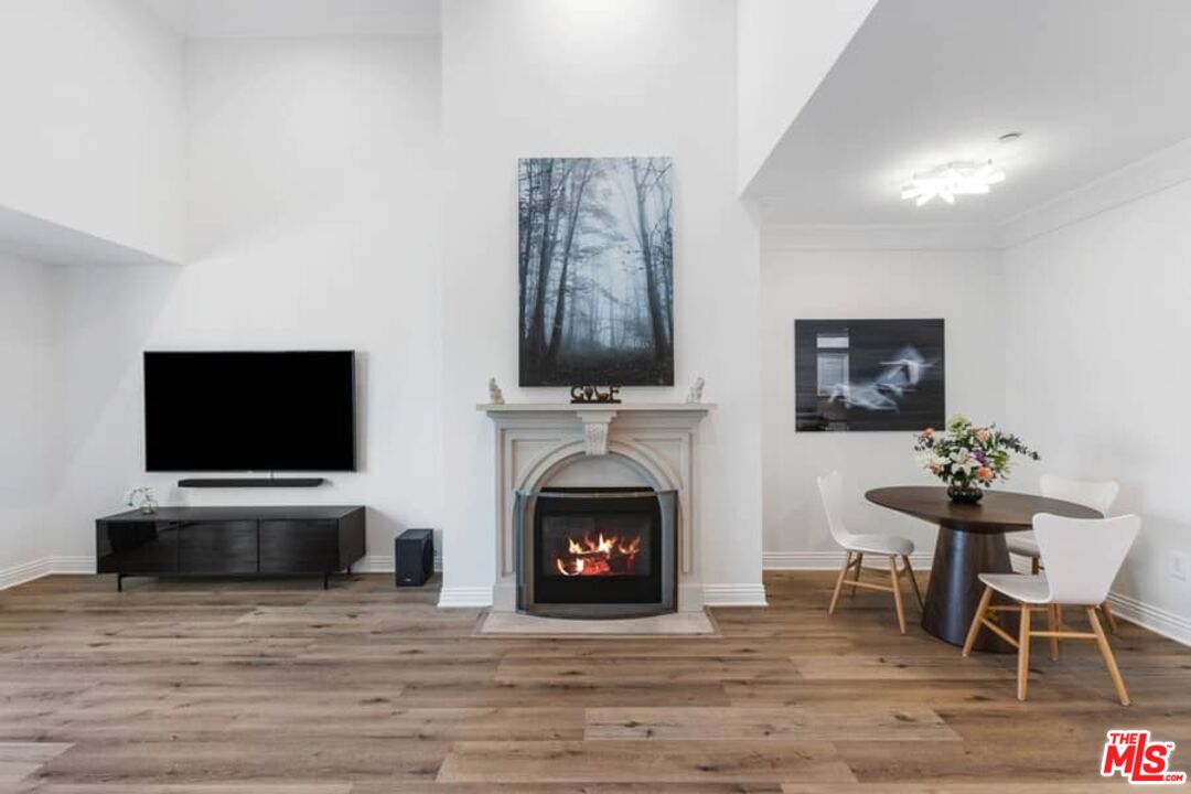 261 South Reeves Drive Beverly Hills, CA 90212 - Photo 4 of 43 a living room with furniture a fireplace and a flat screen tv
