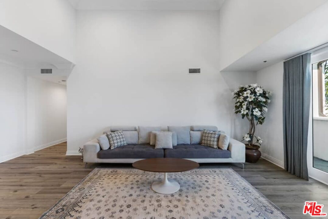 261 South Reeves Drive Beverly Hills, CA 90212 - Photo 6 of 43 a living room with furniture and a rug