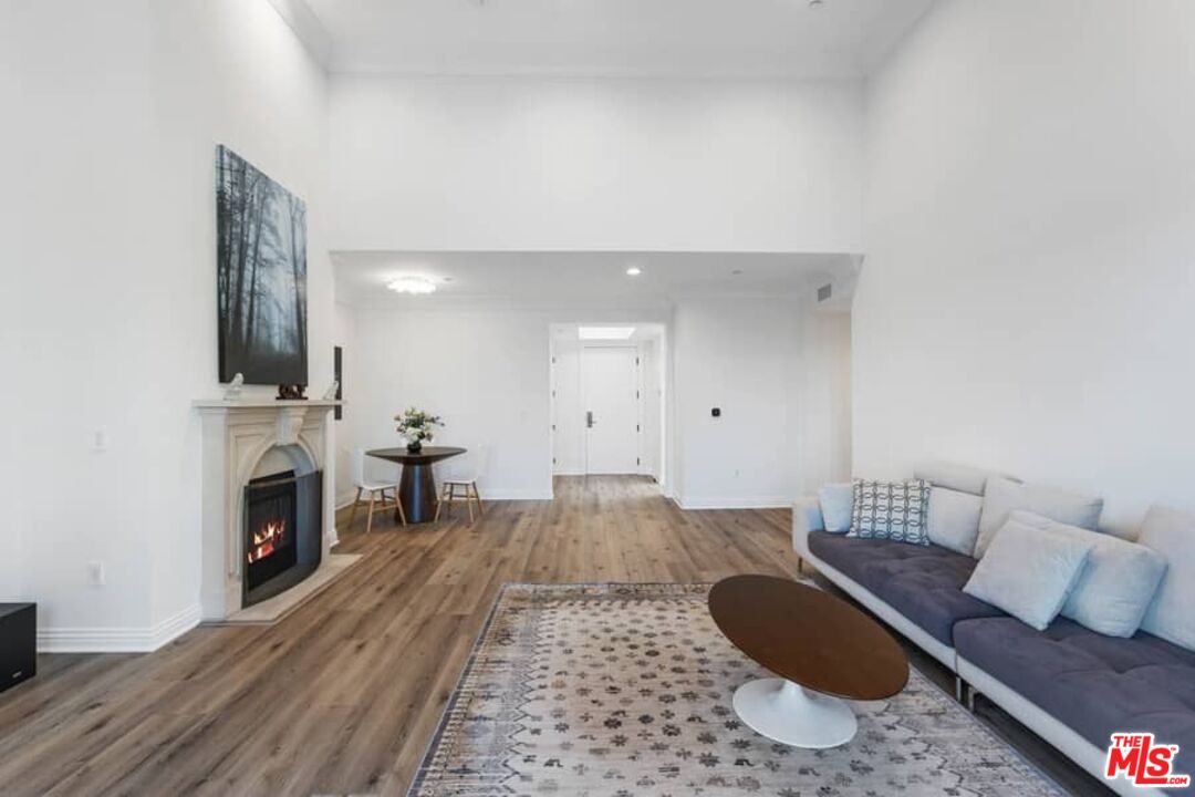 261 South Reeves Drive Beverly Hills, CA 90212 - Photo 7 of 43 a living room with furniture and a fireplace