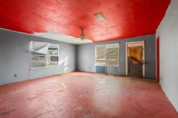 a view of empty room with windows and fireplace