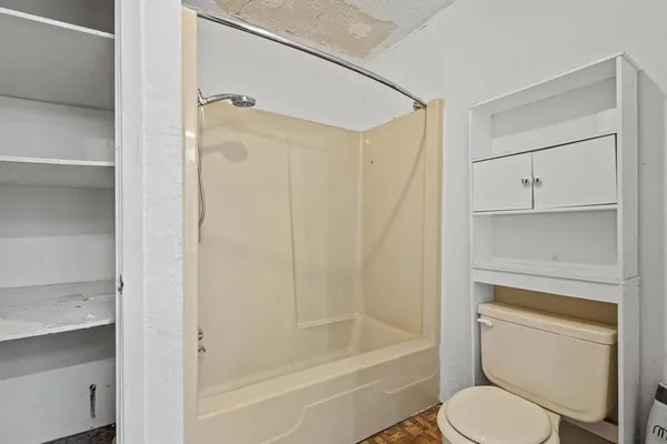 a bathroom with a shower a toilet and a shower