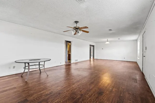 a view of a livingroom with a hardwood floor and a ceiling fan
