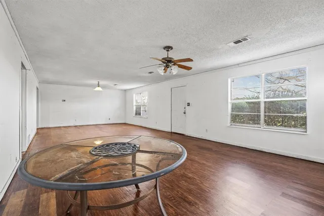 a view of a dining room with a table and chairs