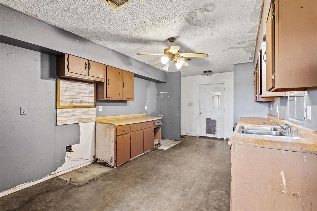 1206 Farm To Market 902 Howe, TX 75459 - Photo 7 of 23 a kitchen with stainless steel appliances granite countertop a sink a stove a refrigerator cabinets and wooden floor