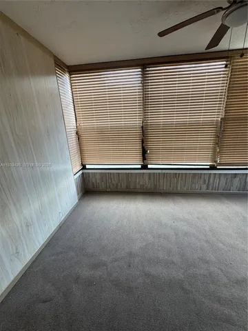 a view of an empty room with windows