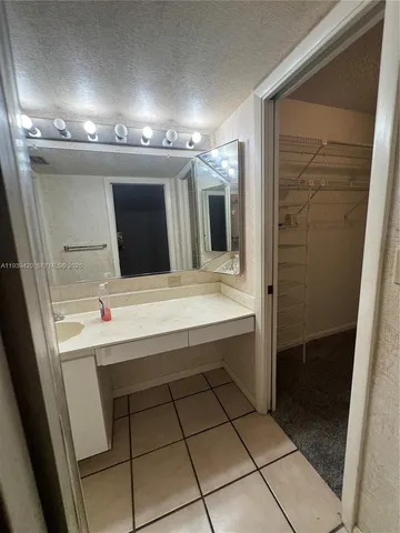 a bathroom with a sink a toilet a mirror and window