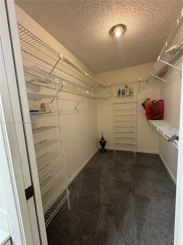 a view of an empty room and wooden floor