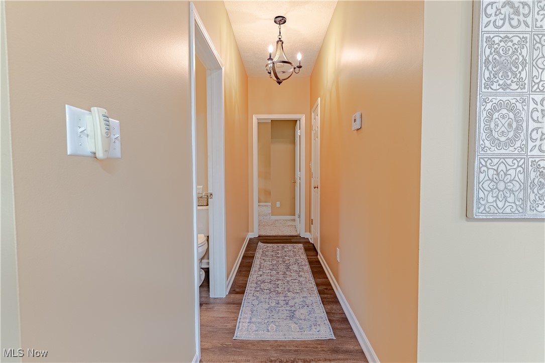 5645 Clingan Road, Unit 23B Struthers, OH 44471 - Photo 15 of 38 Hall featuring a chandelier and wood finished floors