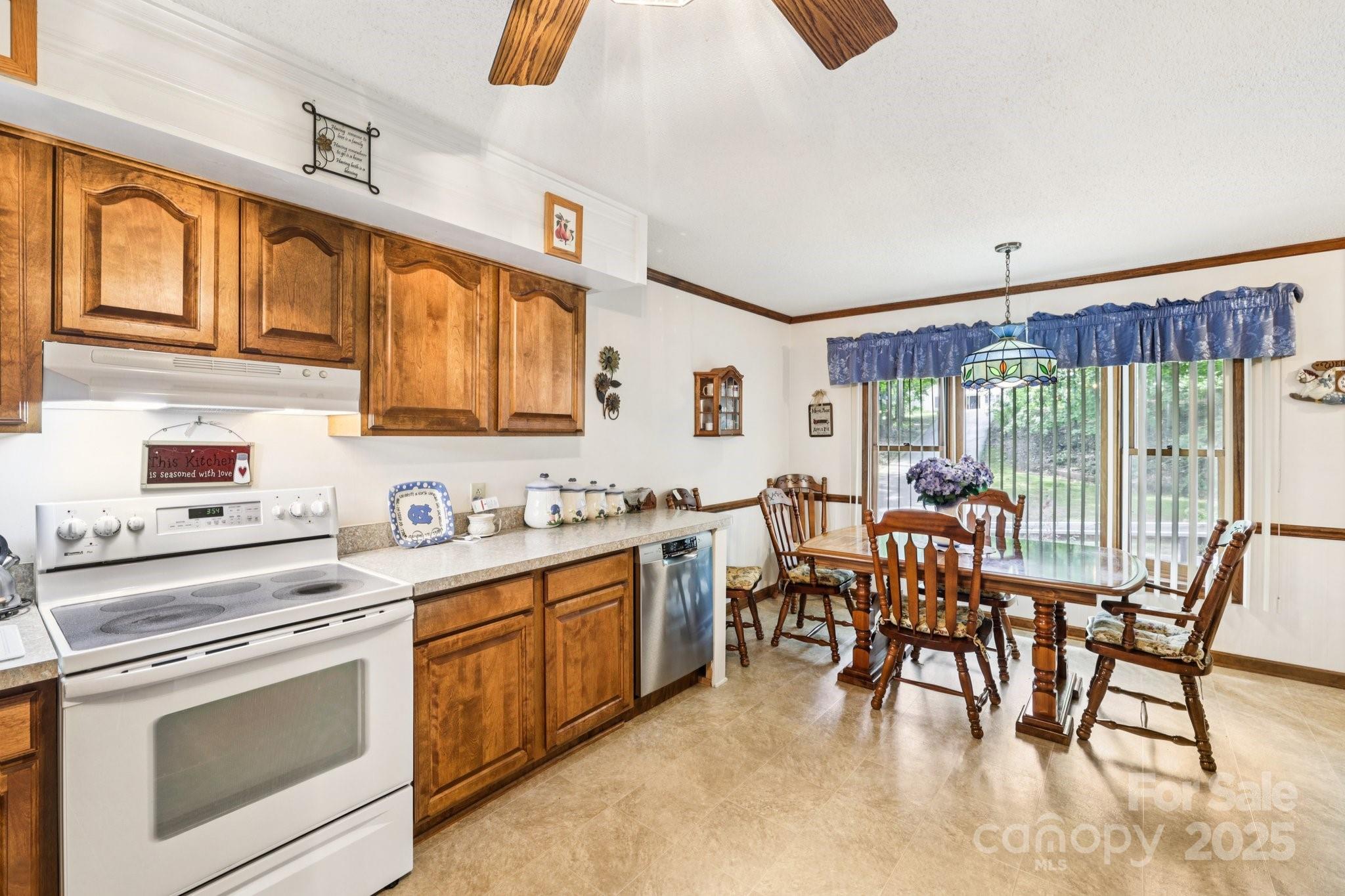 27 Search Drive Concord, NC 28025 - Photo 10 of 26 a kitchen with stainless steel appliances granite countertop a stove a sink and a refrigerator