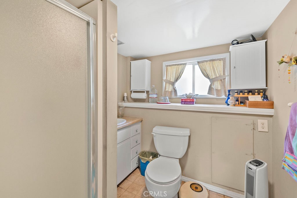 23328 Brookside Road Crestline, CA 92325 - Photo 16 of 40 a bathroom with a toilet sink and window