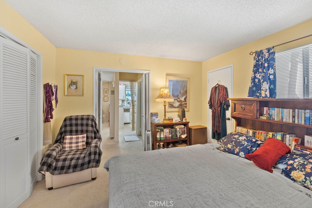 23328 Brookside Road Crestline, CA 92325 - Photo 22 of 40 a bedroom with a bed and wooden floor