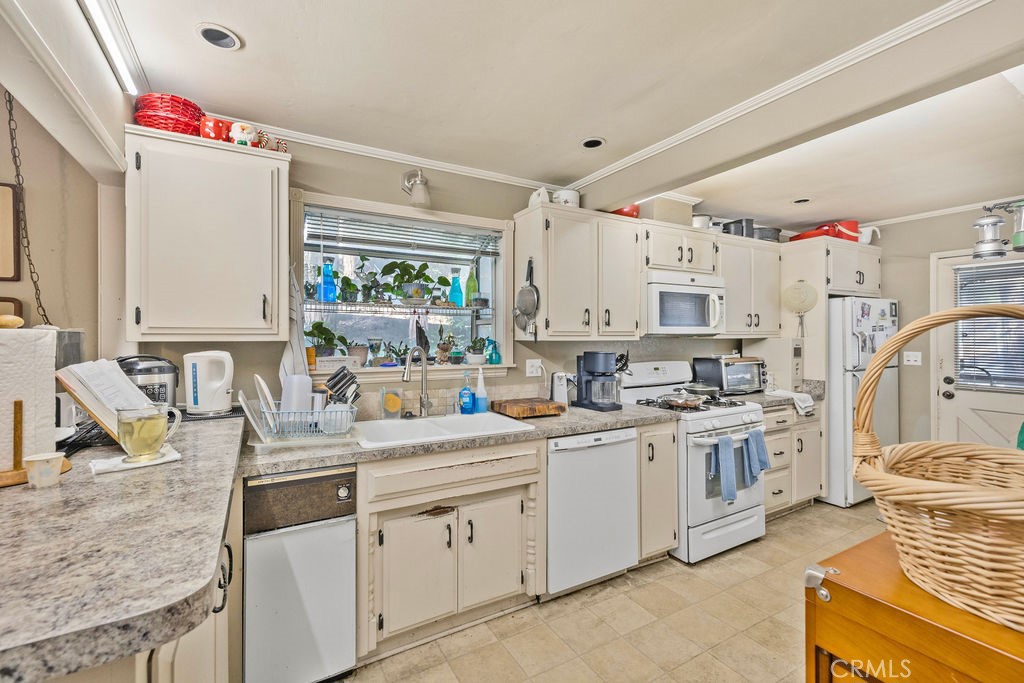 23328 Brookside Road Crestline, CA 92325 - Photo 24 of 40 a kitchen with stainless steel appliances granite countertop a sink stove and refrigerator