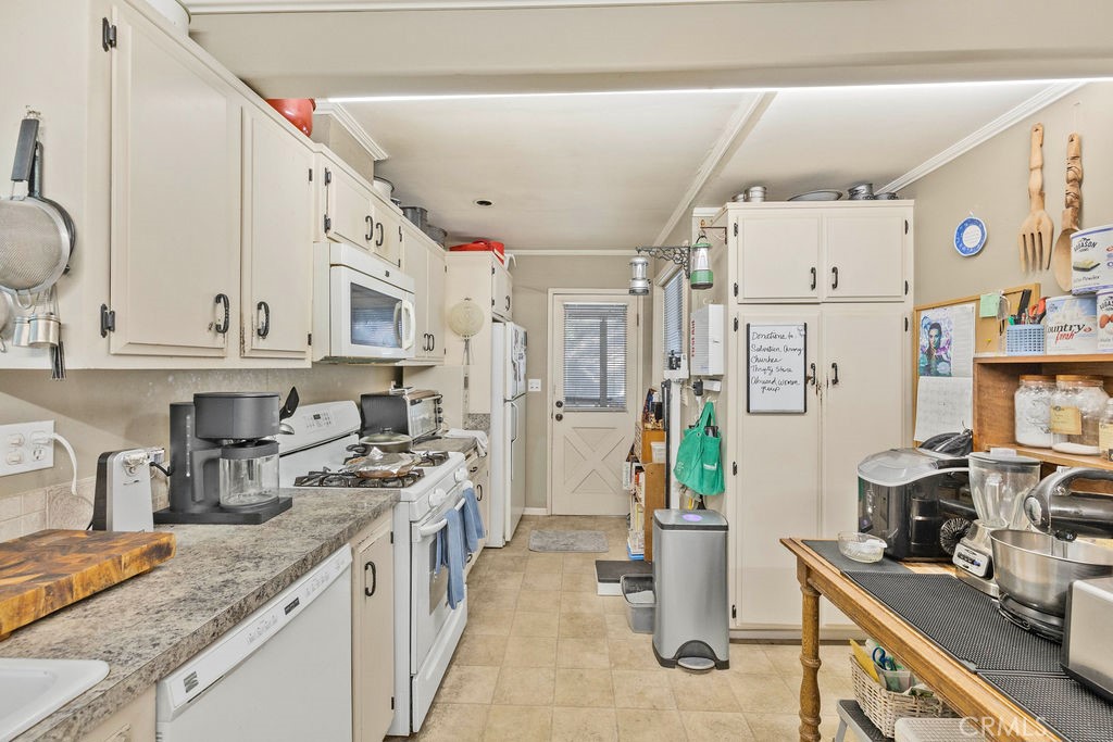 23328 Brookside Road Crestline, CA 92325 - Photo 25 of 40 a kitchen with stainless steel appliances granite countertop a sink stove and refrigerator