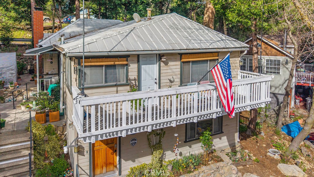 23328 Brookside Road Crestline, CA 92325 - Photo 38 of 40 a view of a house with a wooden deck and furniture