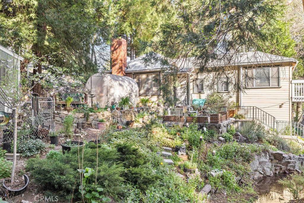 23328 Brookside Road Crestline, CA 92325 - Photo 4 of 40 a backyard of a house with lots of green space and fountain view