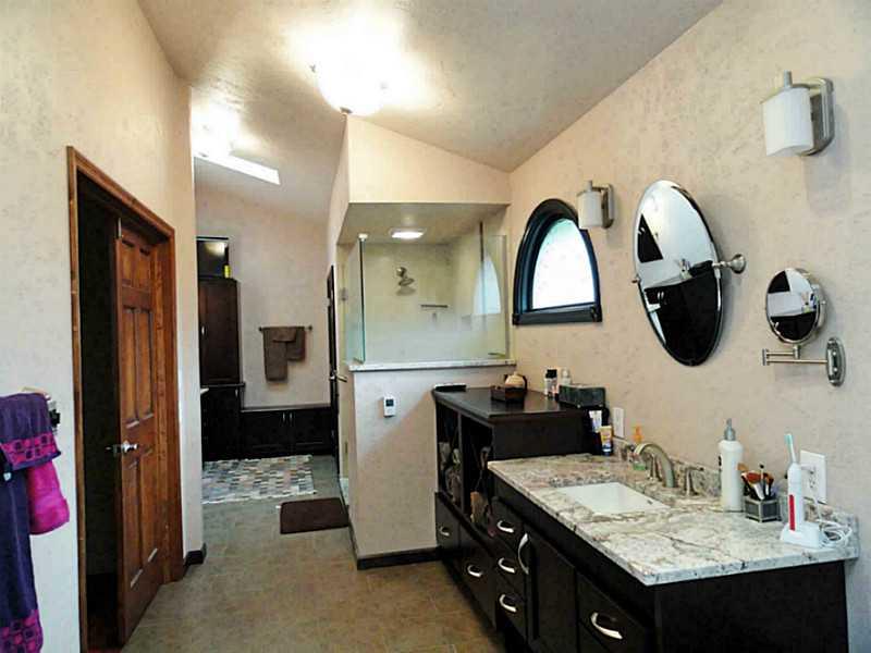 4 Renaissance Drive Irwin, PA 15642 - Photo 19 of 25 Master Bath/Spa. Updated in 2012 with rich dark cabinetry, his & hers areas, custom glass shower, heated floors & large closet with organizer
