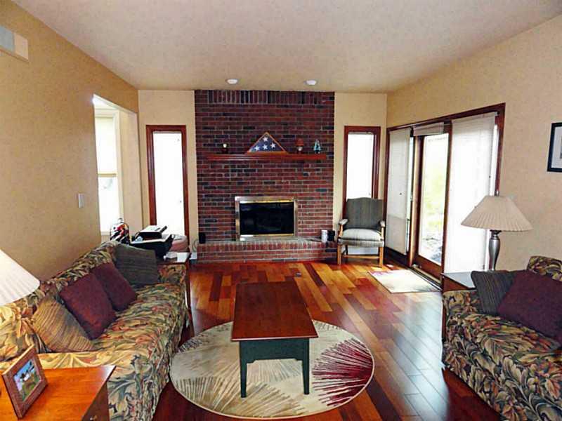 4 Renaissance Drive Irwin, PA 15642 - Photo 8 of 25 Family Room. Kitchen opens to family room with hardwood floors, fireplace & sliding doors to patio