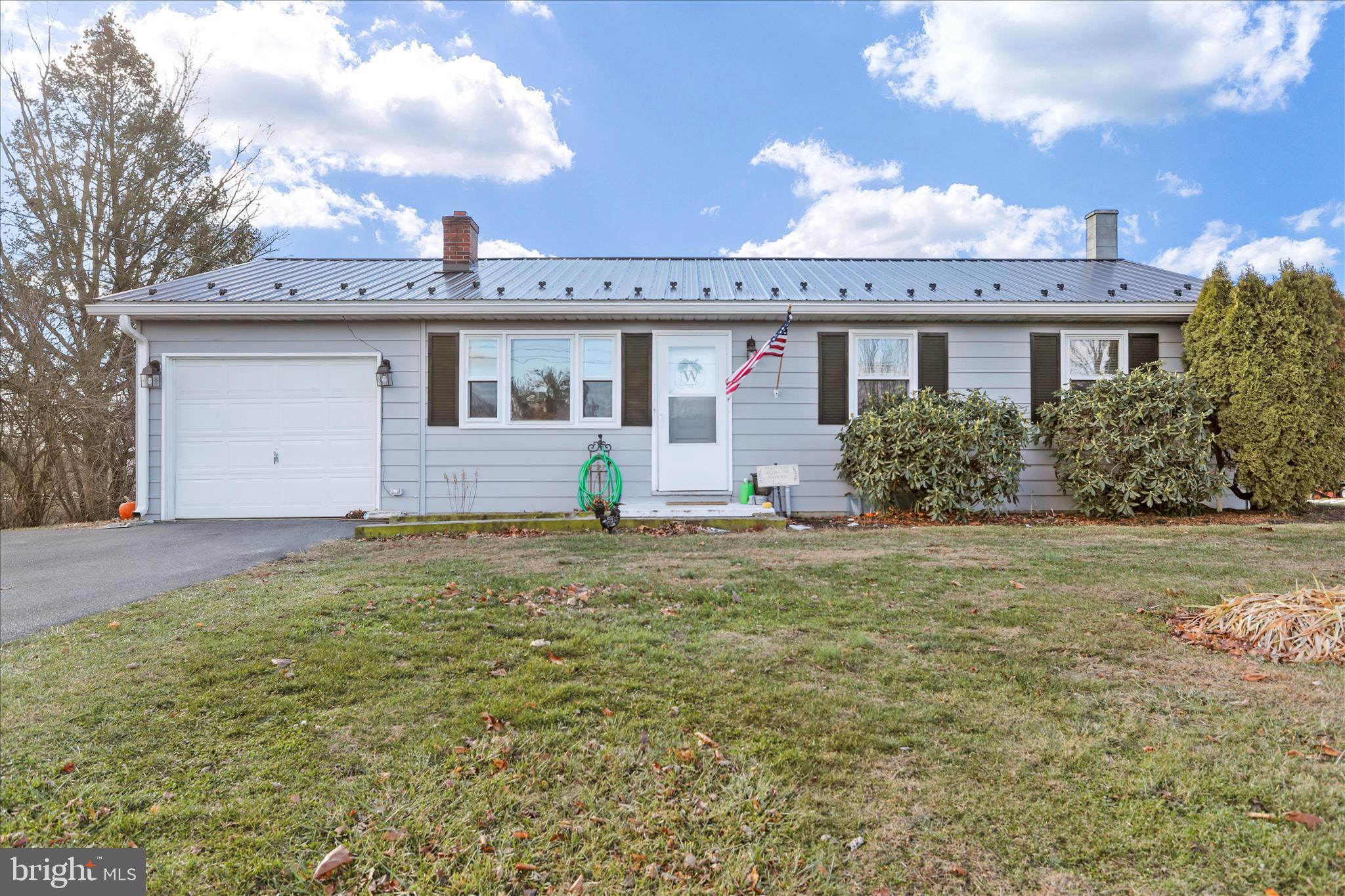 4402 Shatzer Street Chambersburg, PA 17202 - Photo 2 of 30 a front view of a house with garden
