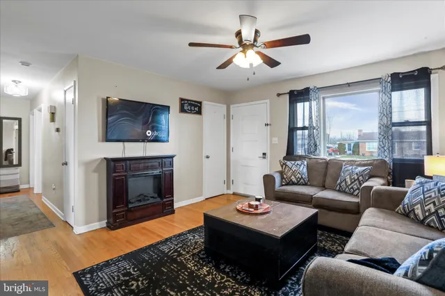 a living room with furniture a fireplace and a flat screen tv