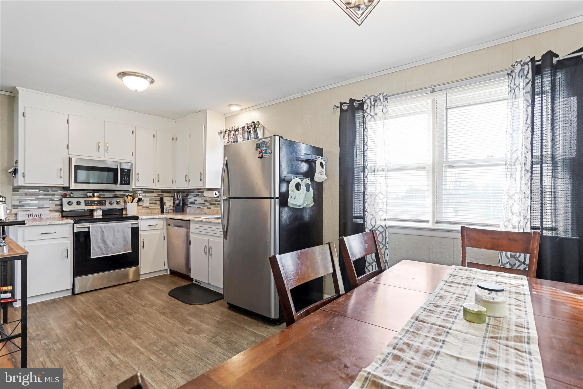4402 Shatzer Street Chambersburg, PA 17202 - Photo 6 of 30 a kitchen with white cabinets and white appliances