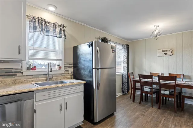 a kitchen with stainless steel appliances granite countertop a refrigerator and a sink