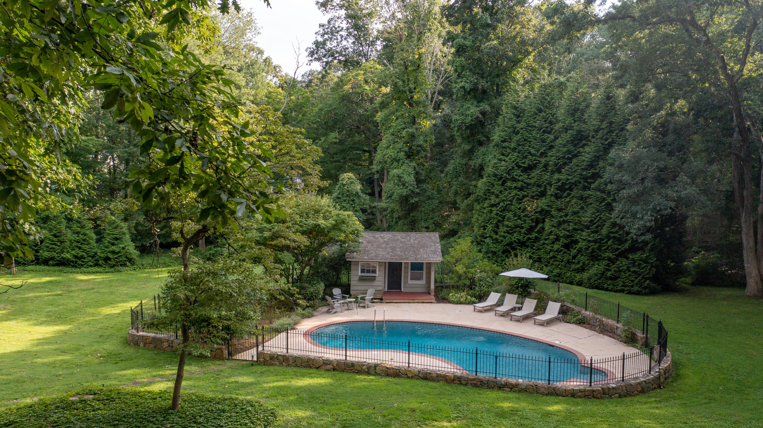 69 Mariomi Road New Canaan, CT 06840 - Photo 2 of 30 a view of a house with a yard deck and a patio