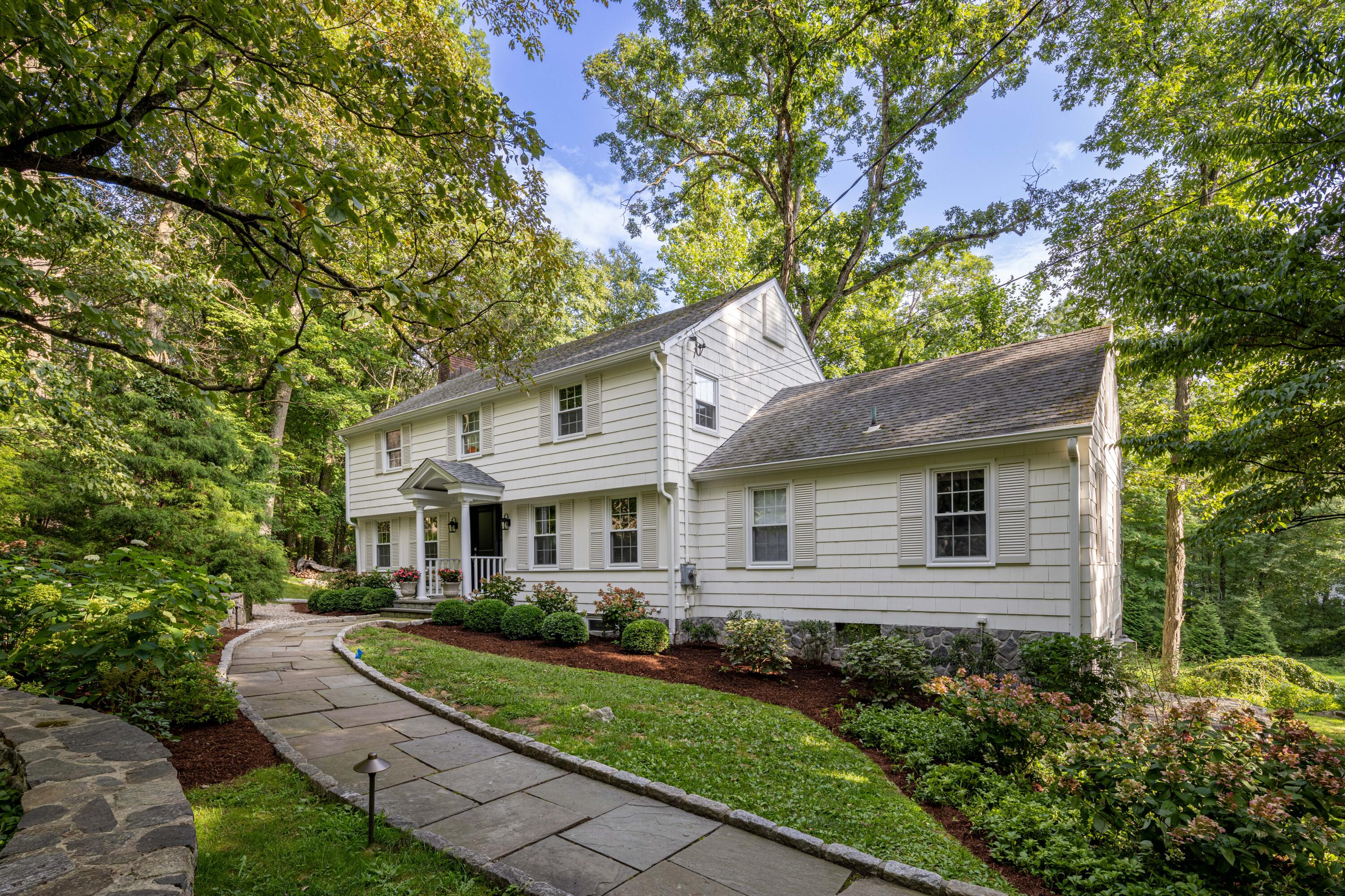 69 Mariomi Road New Canaan, CT 06840 - Photo 3 of 30 a front view of a house with a yard
