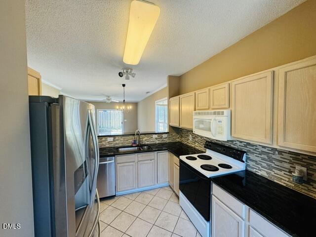 2027 Turtle Point Drive Raleigh, NC 27604 - Photo 6 of 18 a kitchen with stainless steel appliances granite countertop a sink stove and refrigerator