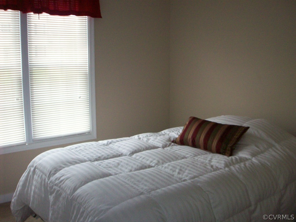 15813 Sandwave Road Chester, VA 23831 - Photo 17 of 24 a bedroom with a bed and a window