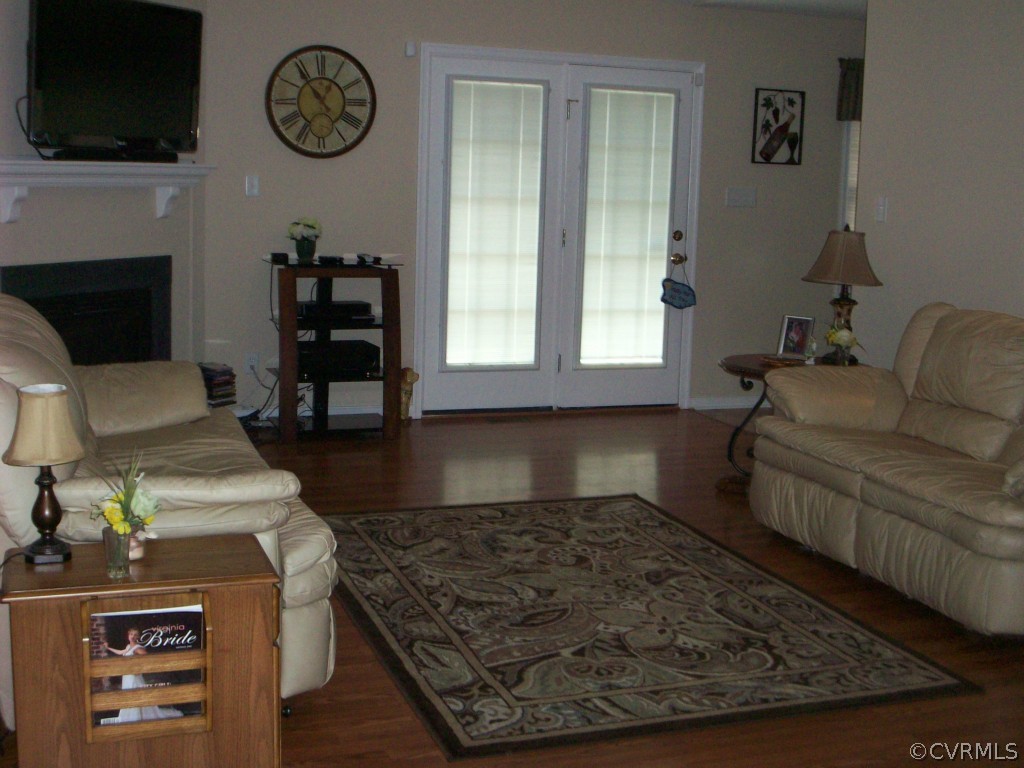 15813 Sandwave Road Chester, VA 23831 - Photo 3 of 24 a living room with furniture a flat screen tv and a fireplace