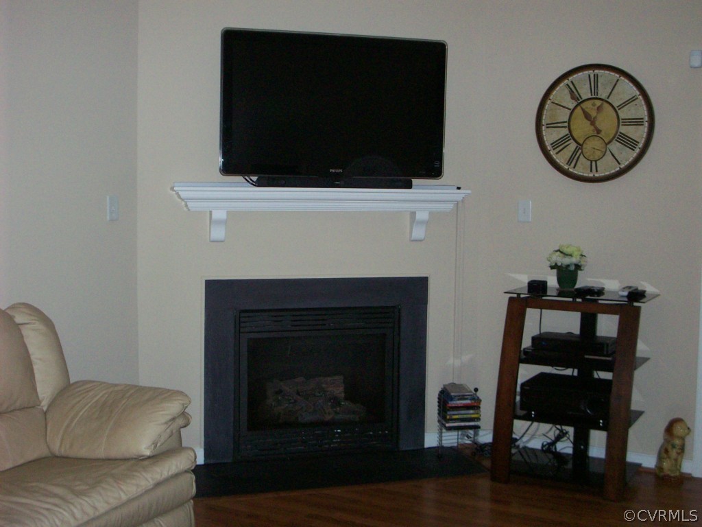 15813 Sandwave Road Chester, VA 23831 - Photo 4 of 24 a living room with a flat screen tv and a fireplace