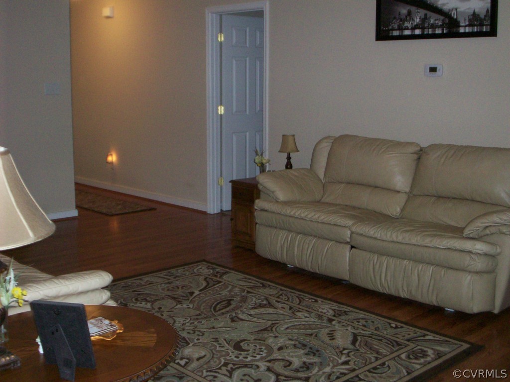 15813 Sandwave Road Chester, VA 23831 - Photo 5 of 24 a living room with a couch and a potted plant