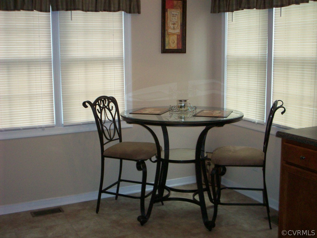 15813 Sandwave Road Chester, VA 23831 - Photo 6 of 24 a view of a dining room with furniture and window
